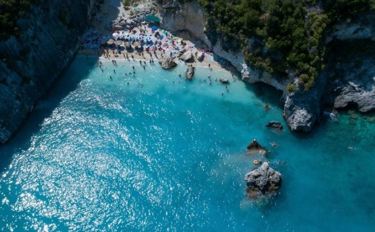 Aerial view of Xigia Beach Zakynthos with tourists swimming in turquoise sulfur waters