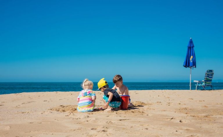 Family beaches Zakynthos – children playing on the sand with calm sea and clear sky