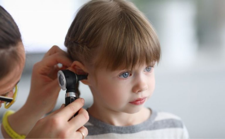 Child having ear examined by doctor for swimmer’s ear at a medical clinic in Zakynthos