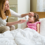 Sick child on holiday in Zakynthos being checked by a doctor
